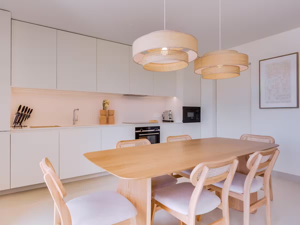 Contemporary fitted kitchen beside a wooden dining table