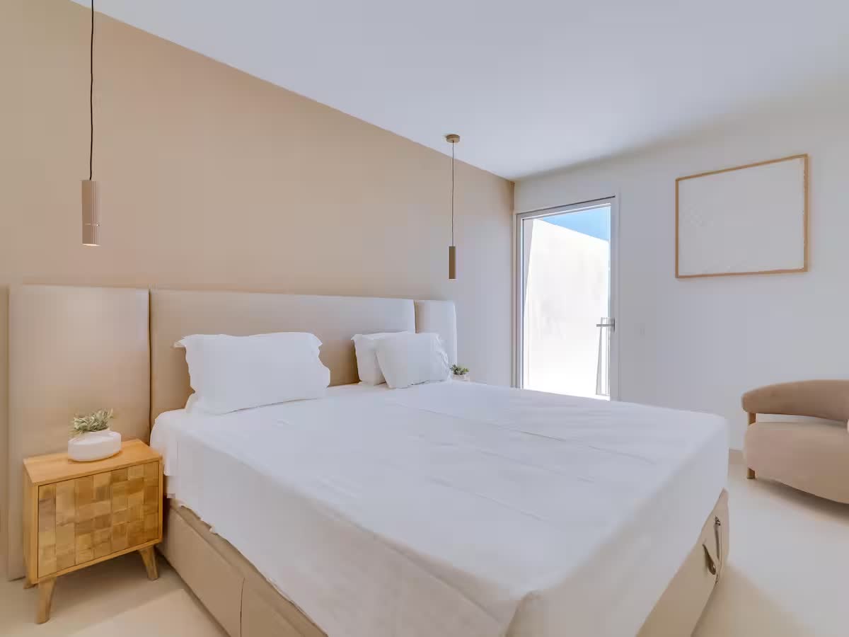 Minimal bedroom with a queen bed and soft neutral finishes