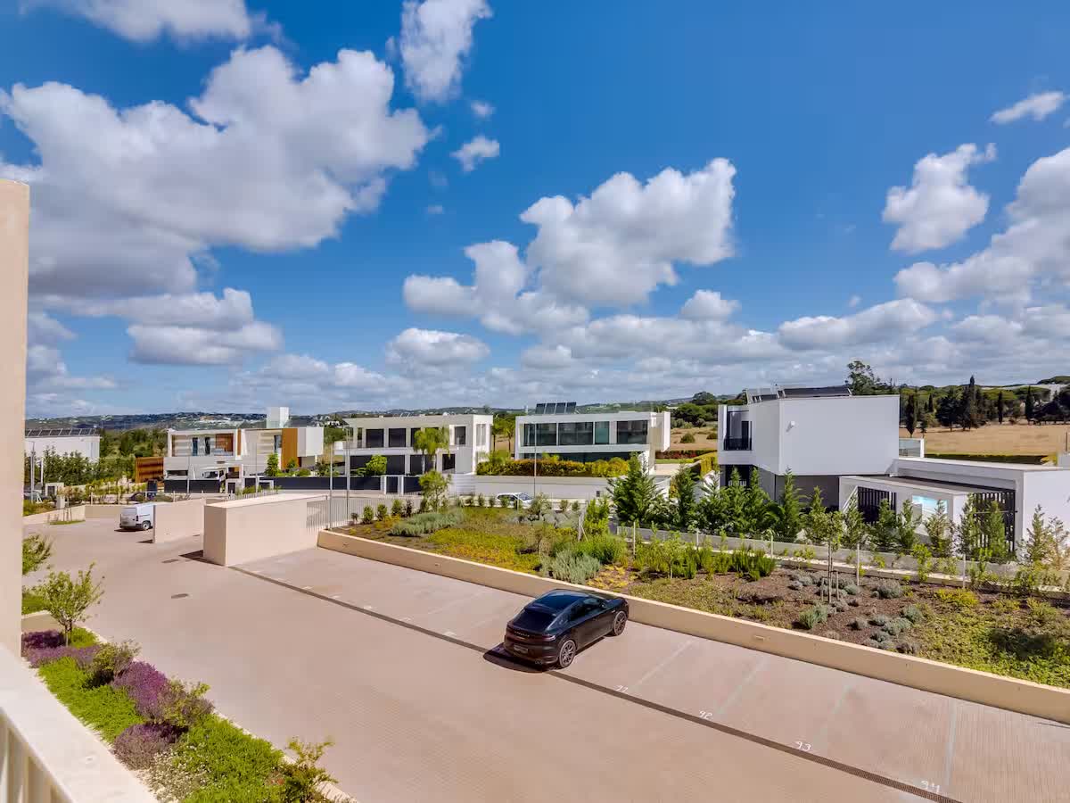 Modern apartment buildings, parking and landscaped surroundings
